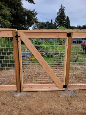 Cedar/Wire Mesh Fence - 4' tall fence with 2x4 wire mesh, cedar frame and 4x4 pressure treated post. Perfect for your family's safety while maintaining open views and decor
