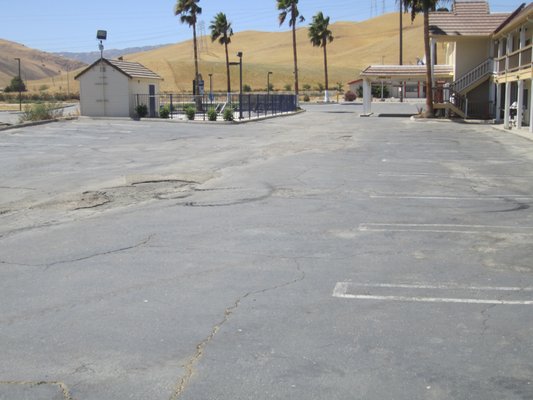 Quality Inn - Customer had a lot of cracks in existing Asphalt parking lot suggested a complete Overlay with 2.5" over existing surface finished off with parking markings