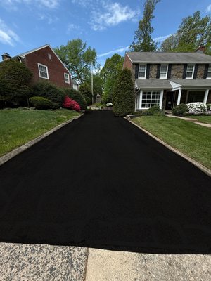 Residential asphalt maintenance in Philadelphia PA. - This completed driveway was power cleaned, trimmed edges, Hot-tar crackfilled, asphalt patched with hot-tar around the edges. double coating of (CTU) Cold Tar. Costomer was happy and love the driveway.