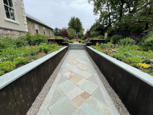 Containers with Stone Walkways and Steps - Customer wanted container planters build around a new walkways and steps leading up to the front door. Our hardscaping crew designed and built them and now our maintenance crew does the planting of perennials.
