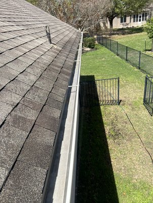 Gutter cleaning - Home in desperate need of gutter cleaning, with years of build up of granules from the shingles and leafs piling up over time Gutter cleaning - Home in desperate need of gutter cleaning, with years of build up of granules from the shingles and leafs piling up over time