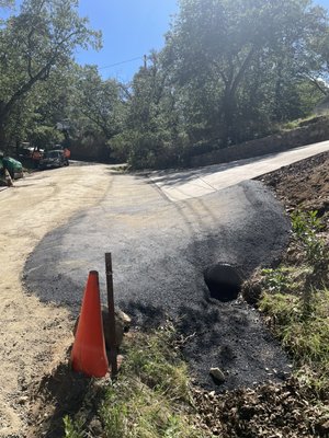 Asphalt apron swell connected off of cement driveway and culvert (drain). Done to prevent erosion (washing out). - This was a new asphalt install called an asphalt apron swell, connected off of cement driveway and culvert (drain). Done to prevent erosion (washing out). This is a prevention that needs to be done before the heavy rains to prevent from washing out. Your driveway will thank you! Asphalt apron swell connected off of cement driveway and culvert (drain). Done to prevent erosion (washing out). - This was a new asphalt install called an asphalt apron swell, connected off of cement driveway and culvert (drain). Done to prevent erosion (washing out). This is a prevention that needs to be done before the heavy rains to prevent from washing out. Your driveway will thank you!