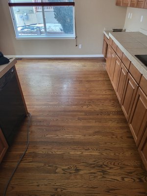 Hardwood floor refinishing - The refinishing of the hardwood floor was done on the old kitchen and floor had a lot of damages.