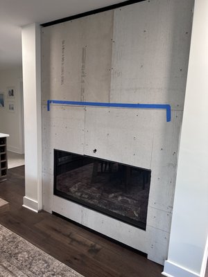 Stone veneer mantle project - We carefully consulted with our client and chose a reclaimed beam that all parties loved. Client chose a white veneer stone that we installed atop an existing gas burning fireplace. Project came together beautifully.