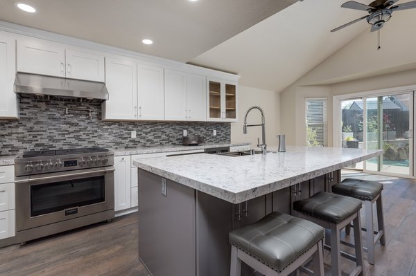 Roseville kitchen renovation - Custom kitchen cabinet renovation with white shaker cabinet door style with gray island with custom sales stone countertop with Farmsink style￼