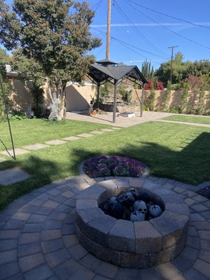 From Overgrown to Outstanding: Complete Backyard Transformation - Before, this yard was overrun with weeds and lacked any functional or visual appeal. Now, it's a stunning outdoor retreat featuring lush turf, stylish pavers, and a custom-built fire pit for gatherings. The addition of a gazebo and a clean, modern landscape design has completely redefined this space, turning it into a relaxing and beautiful area for entertaining or unwinding. Ready to upgrade your outdoor space? Contact us to start your own transformation! From Overgrown to Outstanding: Complete Backyard Transformation - Before, this yard was overrun with weeds and lacked any functional or visual appeal. Now, it's a stunning outdoor retreat featuring lush turf, stylish pavers, and a custom-built fire pit for gatherings. The addition of a gazebo and a clean, modern landscape design has completely redefined this space, turning it into a relaxing and beautiful area for entertaining or unwinding. Ready to upgrade your outdoor space? Contact us to start your own transformation!