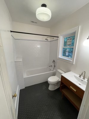 Oceanview bathroom renovation - Bathroom renovation of a house built in 1938 in the Oceanview neighborhood of Norfolk.

We removed all the old fixtures, stripped the walls down to the studs, removed the old tile floor, repaired termite and water damage to the framing, hung new drywall and tiled new floors and a shower surround with a decorative bullnose finish in modern/retro style.