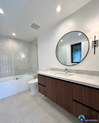 Guest & Master Bathroom | San Jose, CA - This renovation of the guest and master bathrooms showcases a touch of modern elegance. Featuring floor-to-ceiling tiles, sleek glass shower doors, semi-custom floating vanities, updated recessed lighting, and contemporary fixtures, we are so happy with the transformation. Guest & Master Bathroom | San Jose, CA - This renovation of the guest and master bathrooms showcases a touch of modern elegance. Featuring floor-to-ceiling tiles, sleek glass shower doors, semi-custom floating vanities, updated recessed lighting, and contemporary fixtures, we are so happy with the transformation.