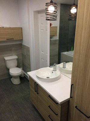 Bathroom remodel with fixture installation – 2023 - Fixture installation for full bathroom remodels and a kitchen. We set toilets, vessel sinks, tub trim, a freestanding tub filler, and an undermount kitchen sink with pull-down faucet.