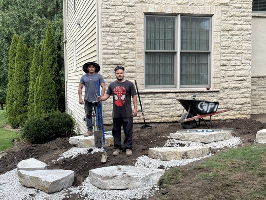 Limestone Outcropping - This front landscape bed was enhanced with large natural limestone outcropping placed along the border for a natural, cohesive finish. The stone adds dimension, structure, and visual interest while complementing the home and surrounding landscaping. Limestone Outcropping - This front landscape bed was enhanced with large natural limestone outcropping placed along the border for a natural, cohesive finish. The stone adds dimension, structure, and visual interest while complementing the home and surrounding landscaping.