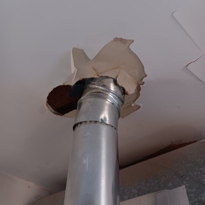Drywall and meatl taped - A roofer fell through the roof and knocked the exhaust off the water heater and made a hole in the drywall