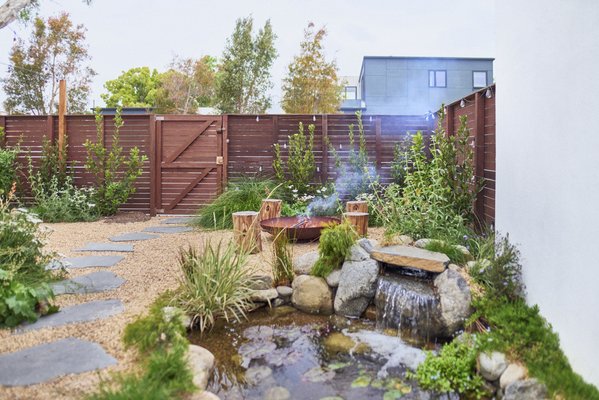 Coolidge project - Removed fake turf and added new gravel and flagstone walkways with California friendly plants around. Added new pond and seating areas. Small patch of grass for dog.