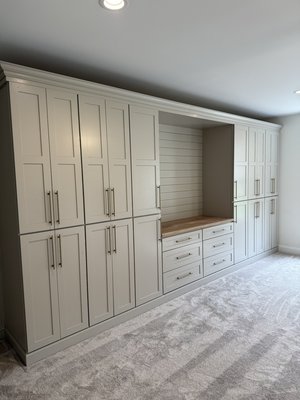 Custom Closet/ Entertainment Center - Custom bedroom built-in featuring a full wall closet system with integrated storage and a central entertainment space.

Finished with shaker-style cabinetry, soft-close drawers, and a solid white oak bench top for a warm, natural accent. Designed to maximize storage while keeping a clean, built-in look.
