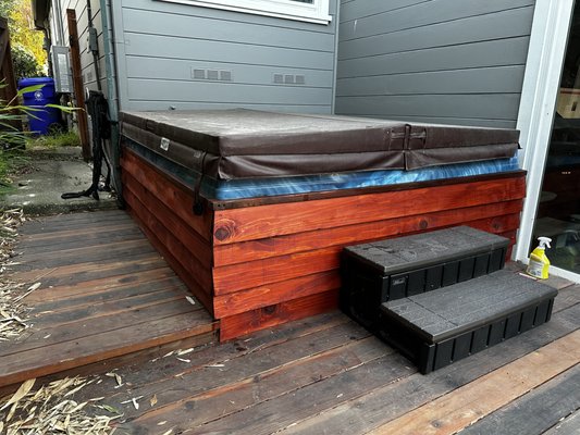 Hot Tub Skirt Rebuild & Cedar Staining - The customer wanted to refresh the appearance of an aging hot tub enclosure while preserving the existing structure. The original wood skirt had extensive weathering, discoloration, and several damaged boards that affected both the appearance and durability of the surround.
I removed the deteriorated trim and replaced the damaged wood panels with new lumber. Before installation, every board was sealed on all sides to protect the wood from moisture, including surfaces that would no longer be accessible after assembly. This extra step helps extend the life of the enclosure and reduces the risk of premature rot.
The new boards were carefully measured, cut, and installed to maintain consistent spacing and clean lines around the hot tub. After installation, the exterior was finished with a high-quality wood stain selected to closely match the existing deck for a cohesive appearance.
To simplify future maintenance, I designed the center front panel as a removable access panel. By removing just two screws, the homeowner can quickly access the hot tub pump and equipment for servicing without dismantling the enclosure.
The finished project provides a durable, weather-resistant hot tub surround with a clean, updated appearance while making future maintenance fast and convenient. Hot Tub Skirt Rebuild & Cedar Staining - The customer wanted to refresh the appearance of an aging hot tub enclosure while preserving the existing structure. The original wood skirt had extensive weathering, discoloration, and several damaged boards that affected both the appearance and durability of the surround.
I removed the deteriorated trim and replaced the damaged wood panels with new lumber. Before installation, every board was sealed on all sides to protect the wood from moisture, including surfaces that would no longer be accessible after assembly. This extra step helps extend the life of the enclosure and reduces the risk of premature rot.
The new boards were carefully measured, cut, and installed to maintain consistent spacing and clean lines around the hot tub. After installation, the exterior was finished with a high-quality wood stain selected to closely match the existing deck for a cohesive appearance.
To simplify future maintenance, I designed the center front panel as a removable access panel. By removing just two screws, the homeowner can quickly access the hot tub pump and equipment for servicing without dismantling the enclosure.
The finished project provides a durable, weather-resistant hot tub surround with a clean, updated appearance while making future maintenance fast and convenient.