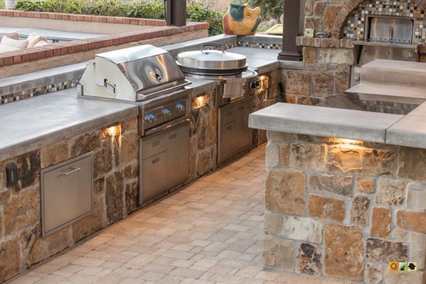 Luxury Outdoor Kitchen & Custom Pizza Oven Paver Design - This custom outdoor kitchen and entertainment space was designed to bring restaurant-quality outdoor cooking and entertaining to the homeowner’s backyard. Featuring a built-in pizza oven, high-end BBQ appliances, high quality pavers, custom countertops, integrated lighting, and a covered pergola, this luxury outdoor living project combines timeless craftsmanship with modern outdoor functionality.

The expansive outdoor kitchen and bar seating area creates the perfect setting for entertaining guests, family gatherings, and year-round Southern California outdoor living. Every detail was carefully designed to blend durable materials, premium appliances, and elegant architectural finishes into a seamless backyard entertainment experience.

At Western Pavers, we specialize in custom outdoor kitchens, pizza ovens, pergolas, fire features, paver patios, landscape architecture, and complete outdoor living renovations throughout San Diego and Orange County.
