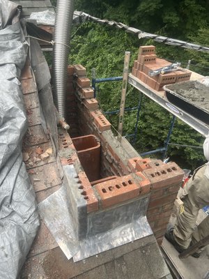 Full flashing roofline rebuild and cap. - Here we did a complete roofline rebuild with a full flashing replacement. A full flashing replacement means that we replaced all step aluminum flashing which goes underneath the shingles and properly tucked the upper portion of the new lead counter flashing into the mortar joints between the brick. This is something we do with all of our rebuilds to insure and guarantee no future leaks! Full flashing roofline rebuild and cap. - Here we did a complete roofline rebuild with a full flashing replacement. A full flashing replacement means that we replaced all step aluminum flashing which goes underneath the shingles and properly tucked the upper portion of the new lead counter flashing into the mortar joints between the brick. This is something we do with all of our rebuilds to insure and guarantee no future leaks!