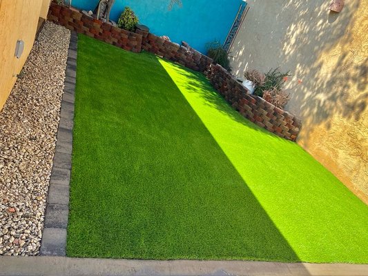 Demo & Turf - For this project, we removed existing pavers, added a base of minus and we installed turf, paver border and decorative rock