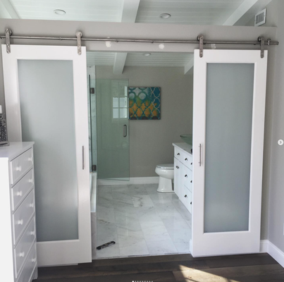Kitchen and Bath Remodel - We did a complete kitchen remodel which included custom cabinets, and beams. We also installed the hardwood flooring throughout the house and barn doors to the master bathroom. Transforming this home into a more modern farmhouse.