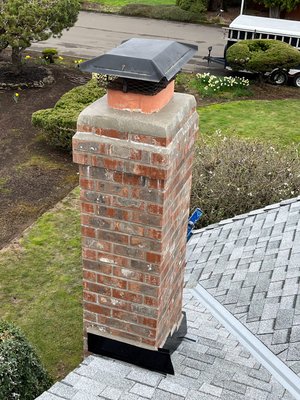 Moss Removal & Flue Tile - This chimney went from dull and weathered to looking brand new with just the right care! Over time, exposure to the elements can cause brick to darken with soot, dirt, and mildew, while the cement crown can crack and deteriorate, making the entire chimney look aged and worn.

To restore it, we started with a thorough wash, bringing out the natural color of the brick and making it look vibrant again. The cement crown received a fresh skim coat, smoothing out imperfections and reinforcing its durability while giving it a clean, like-new appearance.

Now, the entire chimney stands out beautifully—bright, refreshed, and well-protected for years to come. A well-maintained chimney doesn’t just look great; it helps protect your home and adds to its overall curb appeal. If your chimney could use some attention, we’d love to help bring it back to life!