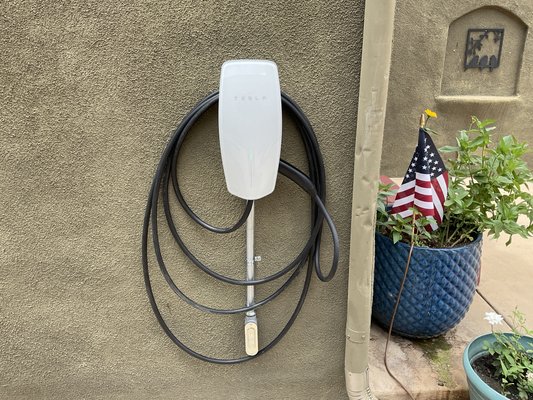 Installing Tesla universal Wall connector - Tesla universal wall connector installed and supplied by Cali Electric Chargers in drive way at customer requested location.