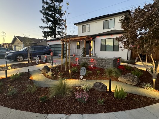 Sunnyvale transformation. Front yard glow-up complete! 2025 - From blank canvas to dream front yard!
We started with a complete demolition, laying the foundation with a new paver driveway, large-format patio and walkway pavers. A retaining wall added privacy without closing off the space, while a custom wooden trellis created a welcoming entry. Finally, colorful plants and lush greenery brought the design to life, completing this Sunnyvale transformation from ordinary to extraordinary! Sunnyvale transformation. Front yard glow-up complete! 2025 - From blank canvas to dream front yard!
We started with a complete demolition, laying the foundation with a new paver driveway, large-format patio and walkway pavers. A retaining wall added privacy without closing off the space, while a custom wooden trellis created a welcoming entry. Finally, colorful plants and lush greenery brought the design to life, completing this Sunnyvale transformation from ordinary to extraordinary!