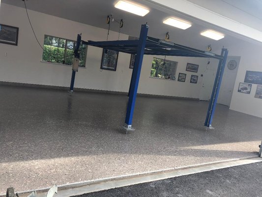 Car Enthusiast Garage - this project the customer wanted the garage to compliment his car collection. The 1" flake has a distinctive look from small flake with about 20% of base coat color showing thru for a more sporadic look.