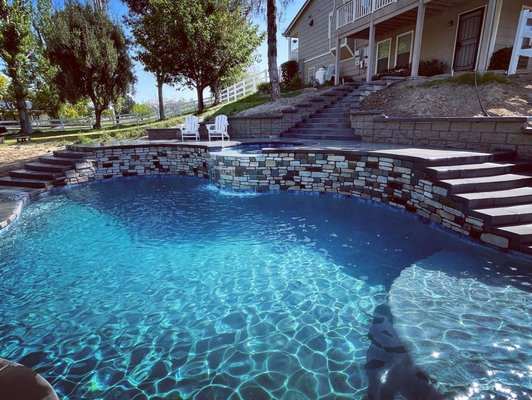Pool Construction - Slopes are fun! Level changes can be challenging, but create unique and useful spaces. Give us a call for a custom pool construction consultation!
