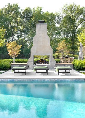 New Outdoor Kitchen and Living Space - We crafted a contemporary outdoor space, skillfully integrating seamless combinations of brick and wood for the outdoor kitchen. This distinctive area perfectly complements our client's passion for hosting large gatherings, featuring a vibrant pool and a sculptural brick fireplace that adds a unique touch to the overall ambiance.