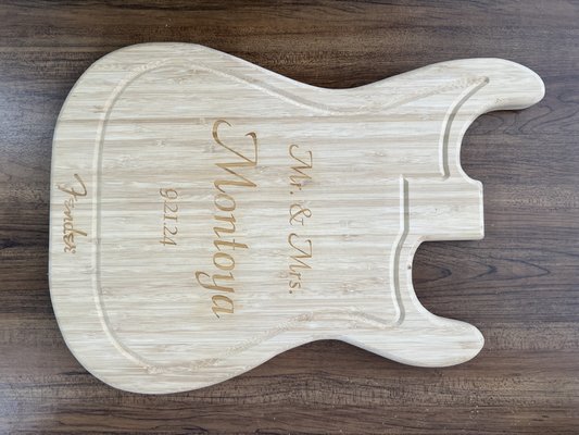 Custom Engraved Guitar Cutting Board for a Wedding Gift - For this project, a customer approached us with a unique and deeply meaningful request: to transform a guitar-shaped cutting board into a personalized wedding gift. We were honored to be part of such a heartfelt gesture and worked closely with the customer to bring their vision to life.

Our process began with a consultation to understand their preferences and the significance of the gift. Together, we selected the perfect font and layout to reflect the couple's style and the sentiment behind the engraving. Once the design was finalized, we meticulously engraved the cutting board, ensuring every detail was crafted to perfection.

Despite a tight deadline of just two days, we prioritized precision and quality, delivering a beautifully engraved piece that exceeded the customer’s expectations. This project allowed us to showcase our ability to collaborate with clients, bring their ideas to fruition, and create a lasting keepsake for a special occasion.

We take pride in the trust our customers place in us for their meaningful moments, and this project was a rewarding example of our commitment to quality, creativity, and customer satisfaction.