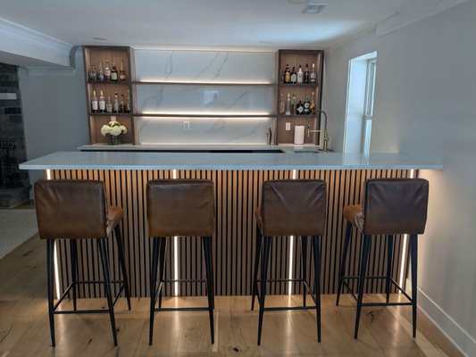 Basement Bar Renovation - A recent basement bar renovation where we helped bring a client’s vision to life with a perfect blend of functionality and flair. The goal? Create a space that was warm and welcoming for family gatherings, yet playful and bold enough for weekend entertaining.

We installed custom ambient lighting that highlighted the natural wood finishes and created a cozy lounge feel, while sleek, color-changing LED accents behind the bar added a fun, modern twist. Smart dimmers and layered lighting zones gave our client total control over the mood—bright and lively for game nights, soft and intimate for late-night chats.

As a women-owned and operated team, we pride ourselves on the little details that make a big difference. This wasn’t just about wiring and fixtures—it was about crafting a space where memories are made. A safe, reliable, and beautifully lit environment where people feel at home. That’s the Cohen Electric touch.