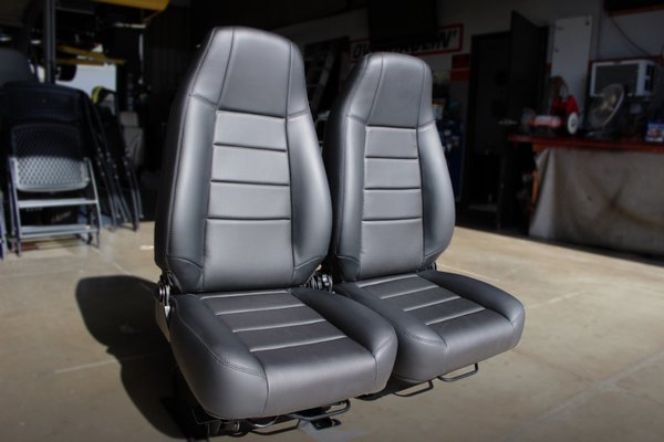 Jeep Leather Seats - These bucket seats were given to us with a plain cloth type material, with the owner of the Jeep wanting to upgrade to leather. We maintained an almost original look with the tucks across the back and bottom, only adding perforated inserts along the same areas. Jeep Leather Seats - These bucket seats were given to us with a plain cloth type material, with the owner of the Jeep wanting to upgrade to leather. We maintained an almost original look with the tucks across the back and bottom, only adding perforated inserts along the same areas.
