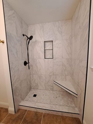 Tub to shower conversion geometrically perfect grout lines - Tub to shower conversion with a floating bench. Check out the perfect grout lines at the niche, bench, and curb. Flawless finish!