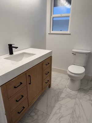 Bathroom Remodel - Complete plumbing installation for a newly remodeled bathroom. Work included setting the vanity and sink with a modern matte black faucet, installing new angle stops and supply lines, and connecting the drain system for a clean, leak-free setup.
The tub and shower system was fully installed with a new mixing valve, matte black shower trim, tub spout, and shower head. Drain, overflow, and waste connections were professionally installed and tested to ensure proper flow and long-term reliability.
Toilet installation was completed with a new wax seal, supply line, and secure mounting for a solid, professional finish. All fixtures were pressure tested and checked to ensure everything operates smoothly.
Clean, precise plumbing to match a modern bathroom design. Bathroom Remodel - Complete plumbing installation for a newly remodeled bathroom. Work included setting the vanity and sink with a modern matte black faucet, installing new angle stops and supply lines, and connecting the drain system for a clean, leak-free setup.
The tub and shower system was fully installed with a new mixing valve, matte black shower trim, tub spout, and shower head. Drain, overflow, and waste connections were professionally installed and tested to ensure proper flow and long-term reliability.
Toilet installation was completed with a new wax seal, supply line, and secure mounting for a solid, professional finish. All fixtures were pressure tested and checked to ensure everything operates smoothly.
Clean, precise plumbing to match a modern bathroom design.