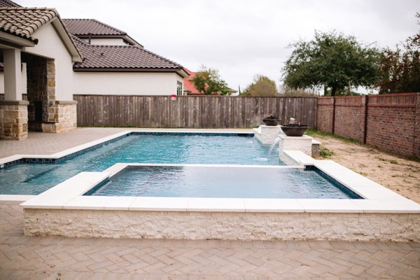 Traditional Linear Pool/Spa with Fire Bowls - Avree Custom Pools has been creating backyard retreats for decades, transforming outdoor spaces into an oasis that can be enjoyed year-round. Designing and building projects that fit your lifestyle and unique preferences with excellence is our mission.