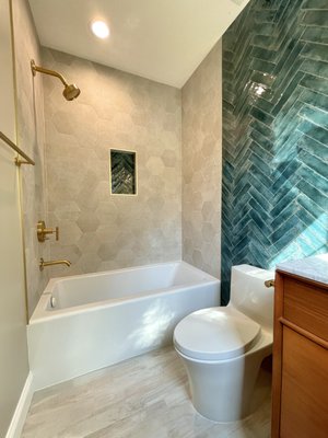 Modern Mid-Century Bathroom - Mid-century modern meets jewel tones — teal herringbone, hex tile & brushed brass.