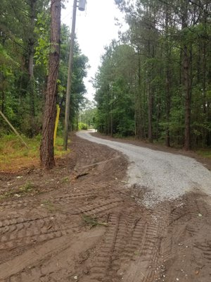 Land Clearing for Gravel Driveway - This project was completed for a home owner that wanted a private residence tucked in the woods. We designed the site layout and and S Curve driveway to block traffic viewing the interior of the property. The long driveway required the path to be laser measured for sloped for water drainage at several points of elevation.