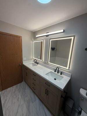 Insurance Claim Bathroom Remodel – Complete Renovation-in Beach Park - Luxury Bathroom Remodel ✨
This bathroom transformation features a beautiful new marble-look porcelain tile floor, a custom double vanity with a quartz countertop, modern matte black faucets, LED backlit mirrors, upgraded vanity lighting, and a fresh paint finish. Every detail was installed with precision to create a clean, modern, and functional space.
Serving Waukegan, Gurnee, Libertyville, Lake Forest, Northbrook, Vernon Hills, and the surrounding Chicagoland area. Contact Renova Tiles & Remodeling for professional bathroom remodeling, tile installation, flooring, and custom renovations. Insurance Claim Bathroom Remodel – Complete Renovation-in Beach Park - Luxury Bathroom Remodel ✨
This bathroom transformation features a beautiful new marble-look porcelain tile floor, a custom double vanity with a quartz countertop, modern matte black faucets, LED backlit mirrors, upgraded vanity lighting, and a fresh paint finish. Every detail was installed with precision to create a clean, modern, and functional space.
Serving Waukegan, Gurnee, Libertyville, Lake Forest, Northbrook, Vernon Hills, and the surrounding Chicagoland area. Contact Renova Tiles & Remodeling for professional bathroom remodeling, tile installation, flooring, and custom renovations.
