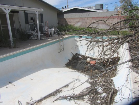 Exterior Clean up & Paint - This work was exterior in nature. MVBGC and their subcontractors installed a code approved pool gate, cleaned up the yard, removed debris from the pool, installed a pool cover, replaced damaged fascia boards, and refinished the exterior stucco and paint.