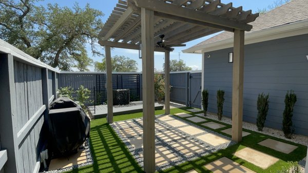 Lavaca Backyard Renovation - Unhappy with their current small yard space; the homeowners wanted to change the look and, more importantly, the feel of their backyard. We put together a design that would make the space larger and overall more functional. We started by moving the fence back to the property line and painting to match, once finished we cleared out the entire space to prepare for the custom pergola, stained to match as well. Electrical was run to the pergola, water feature, and grill. We installed Philips Hue sconces against the pergola posts along with an outdoor fan in the center. We used stepping stones to create the walkway and patio with grey stone and artificial turf in between for a more natural look. All plants were chosen for their low maintenance and have dedicated irrigation for each unique planting bed. Metal trellises were added to block out electrical boxes and give a background of climbing jasmine to the water fountain. After installation of the fountain we added a small composite deck to give the space a new dimension with enough area for a chair on either side. Home owner was thrilled with the finished product and we will be continuing the on going maintenance of the property. Included in this project was the a cleanup and replanting of the front yard. Lavaca Backyard Renovation - Unhappy with their current small yard space; the homeowners wanted to change the look and, more importantly, the feel of their backyard. We put together a design that would make the space larger and overall more functional. We started by moving the fence back to the property line and painting to match, once finished we cleared out the entire space to prepare for the custom pergola, stained to match as well. Electrical was run to the pergola, water feature, and grill. We installed Philips Hue sconces against the pergola posts along with an outdoor fan in the center. We used stepping stones to create the walkway and patio with grey stone and artificial turf in between for a more natural look. All plants were chosen for their low maintenance and have dedicated irrigation for each unique planting bed. Metal trellises were added to block out electrical boxes and give a background of climbing jasmine to the water fountain. After installation of the fountain we added a small composite deck to give the space a new dimension with enough area for a chair on either side. Home owner was thrilled with the finished product and we will be continuing the on going maintenance of the property. Included in this project was the a cleanup and replanting of the front yard.