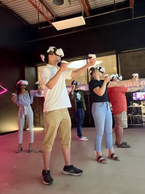 VR Free Roam Action Adventure - Absolute blast! Play WITH your game partners or AGAINST them! Large 20'x20' gaming arena accommodates up to 6 players simultaneously. Get a haptic vest for more immersive experience and feel every zombie touching your shoulder.