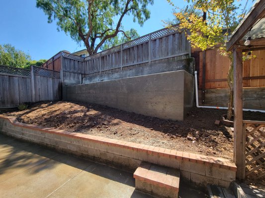 Retaining Wall - The house has a failing retaining wall in the backyard. We demolished the old retaining wall and constructed a new concrete retaining wall.