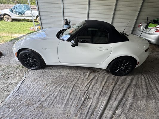 2-Year Ceramic Coating – $800 - This package delivers an affordable, professional-grade ceramic coat that lasts up to 2 years. The process starts with a deep exterior clean, including a clay bar treatment, paint decontamination, and a full polish to restore clarity and shine. After polishing, I perform a quick detail to ensure the surface is flawless before applying the ceramic coating.

The result is a mirror-like finish with rich gloss and hydrophobic protection, allowing water, dirt, and grime to slide right off. For this white Miata, I even corrected scuff marks from a rear-end accident, restoring the paint’s smooth, reflective look.

As an added bonus, this package also includes a deep interior clean, leaving the vehicle spotless inside and out.

Longer-lasting ceramic coatings are also available for those who want maximum durability and protection.