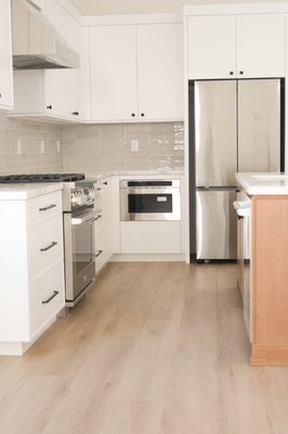 Custom Kitchen & Vanity Remodel in Costa Mesa - This Costa Mesa remodel included a complete kitchen transformation featuring custom cabinetry, quartz countertops, a full-height backsplash, premium storage solutions including blind corner pull-outs, and matching bathroom vanities. The goal was to create a bright, modern, and highly functional space tailored to the homeowner's lifestyle.
