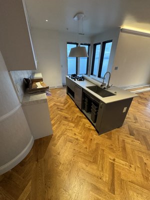 Project in Kirkland by the water - We glue underlayment plywood, another underlayment, and then did a glue down herringbone, and then we stain golden oak  we put down finish and came back when everything was done to do a final goal