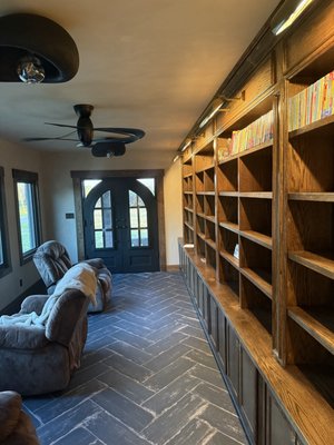 sunroom to library - It was a sun room to  library conversion. herringbone floor tile and red oak custom made selfs.