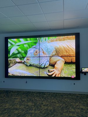 4 screen video wall with 86” TVs and HDMI matrix - Client requested that we build him a four panel matrix Video Wall to achieve four different screens or One Screen depending on presentation
Client provided the TVs, which were Hisense 86 inch screens- we did our best to make them as flush as possible by inverting the top two screens and programming them to be right side up when viewing content. All control is done with a URCMX 890 remote. Content provided by 4 Apple TVs for individual viewing on each screen and connections for a laptop to view for presentations on four panels combined 4 screen video wall with 86” TVs and HDMI matrix - Client requested that we build him a four panel matrix Video Wall to achieve four different screens or One Screen depending on presentation
Client provided the TVs, which were Hisense 86 inch screens- we did our best to make them as flush as possible by inverting the top two screens and programming them to be right side up when viewing content. All control is done with a URCMX 890 remote. Content provided by 4 Apple TVs for individual viewing on each screen and connections for a laptop to view for presentations on four panels combined