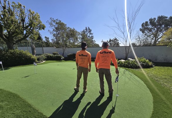 800 sf putting green - We recently had the pleasure of completing a custom 800-square-foot putting green installation for one of our valued clients. The project involved transforming a spacious backyard into the ultimate golf practice area. Our team began by carefully selecting the perfect location, ensuring proper drainage and a level surface for an authentic playing experience. 800 sf putting green - We recently had the pleasure of completing a custom 800-square-foot putting green installation for one of our valued clients. The project involved transforming a spacious backyard into the ultimate golf practice area. Our team began by carefully selecting the perfect location, ensuring proper drainage and a level surface for an authentic playing experience.