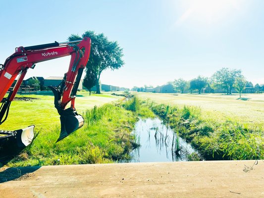 Ditch excavation and hardscape in owasso Oklahoma - We cleared out this ditch quickly and efficiently, removing all excess dirt and debris. To finish it off, we lined the edges with rock, giving it a clean look while also improving irrigation control and erosion protection.

Simple, effective, and built to last.