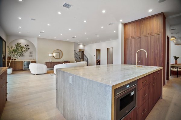 Sophisticated Kitchen Remodel in Studio City, CA - This kitchen remodel blends timeless design with modern functionality, transforming the heart of the home into a bright, open, and highly efficient space. We reconfigured the layout to improve flow and maximize storage, installed custom warm wood cabinetry with sleek bronze hardware, and added premium travertine countertops for a durable, elegant surface that promotes healthier living through easy maintenance and low-VOC materials. High-end stainless-steel appliances, including a professional gas range and integrated microwave, pair with energy-efficient recessed lighting and open shelving to create the perfect balance of style and performance. The spacious island with plush bar stools invites family gatherings, while the seamless connection to the living area enhances everyday living and effortless entertaining—all completed with minimal disruption and at competitive prices that ensure superior results without overpaying. The result is a sophisticated kitchen tailored for joyful meals and lasting value, empowering you to live happier and healthier right away. Services include: Layout Reconfiguration, Custom Cabinetry, Countertop Installation, Appliance Integration, Lighting Design, and Open-Concept Enhancements. Sophisticated Kitchen Remodel in Studio City, CA - This kitchen remodel blends timeless design with modern functionality, transforming the heart of the home into a bright, open, and highly efficient space. We reconfigured the layout to improve flow and maximize storage, installed custom warm wood cabinetry with sleek bronze hardware, and added premium travertine countertops for a durable, elegant surface that promotes healthier living through easy maintenance and low-VOC materials. High-end stainless-steel appliances, including a professional gas range and integrated microwave, pair with energy-efficient recessed lighting and open shelving to create the perfect balance of style and performance. The spacious island with plush bar stools invites family gatherings, while the seamless connection to the living area enhances everyday living and effortless entertaining—all completed with minimal disruption and at competitive prices that ensure superior results without overpaying. The result is a sophisticated kitchen tailored for joyful meals and lasting value, empowering you to live happier and healthier right away. Services include: Layout Reconfiguration, Custom Cabinetry, Countertop Installation, Appliance Integration, Lighting Design, and Open-Concept Enhancements.