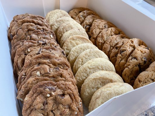 Cookie Box - This is an assorted box of cookies available to order. Flavors available would include: Chocolate chip, Snickerdoodle, Sugar, Oatmeal Raisin, And Nut Chip! Minimum of 1 Dozen is required.